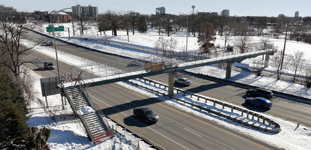 Before: A photo of the old pedestrian bridge over Highway 62. This bridge was only accessible by stairs. 